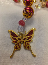 Load image into Gallery viewer, Close-up of a beaded bracelet with a gold and red butterfly charm on a light gray background.