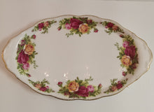 Load image into Gallery viewer, Decorative oval plate with floral patterns on a plain background
